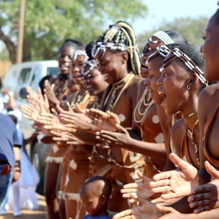 A vibrant display of traditional dance and cultural attire at an outdoor event.